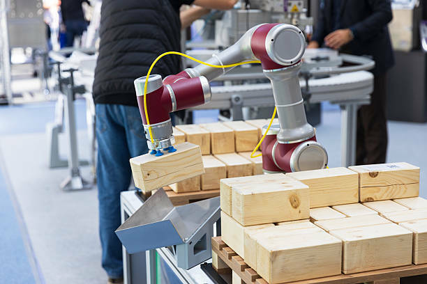 Collaborative robot arm handling wooden blocks in an industrial pick-and-place application